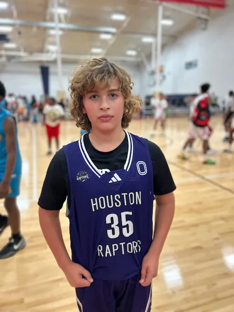 alt="young basketball star Niles Neumann shooting three"