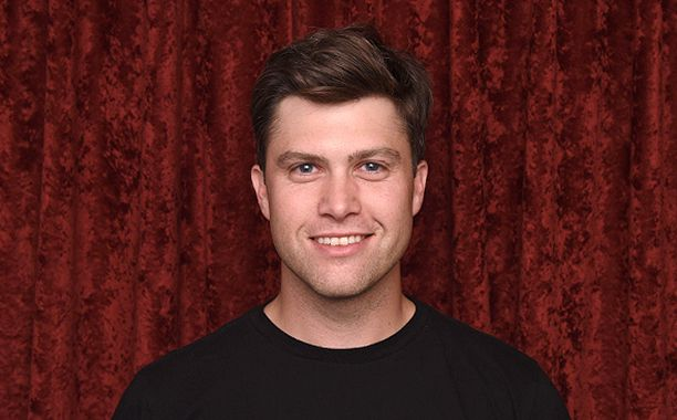 "Colin Jost standing on red carpet showing his height next to Scarlett Johansson"