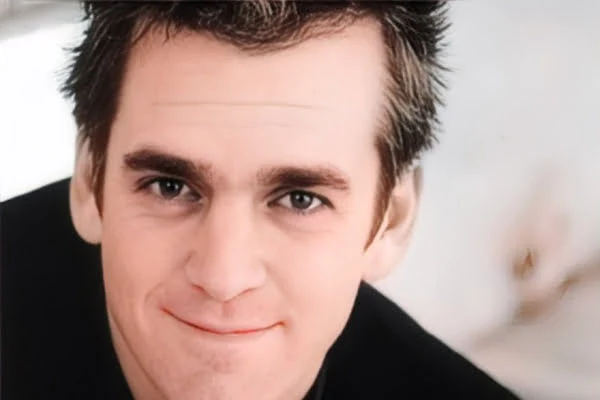 alt="Will Theron Roth portrait smiling in natural light"