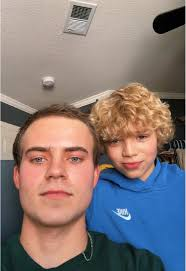 alt="Francis Wilkins and Nick Wilkins filming a TikTok video"